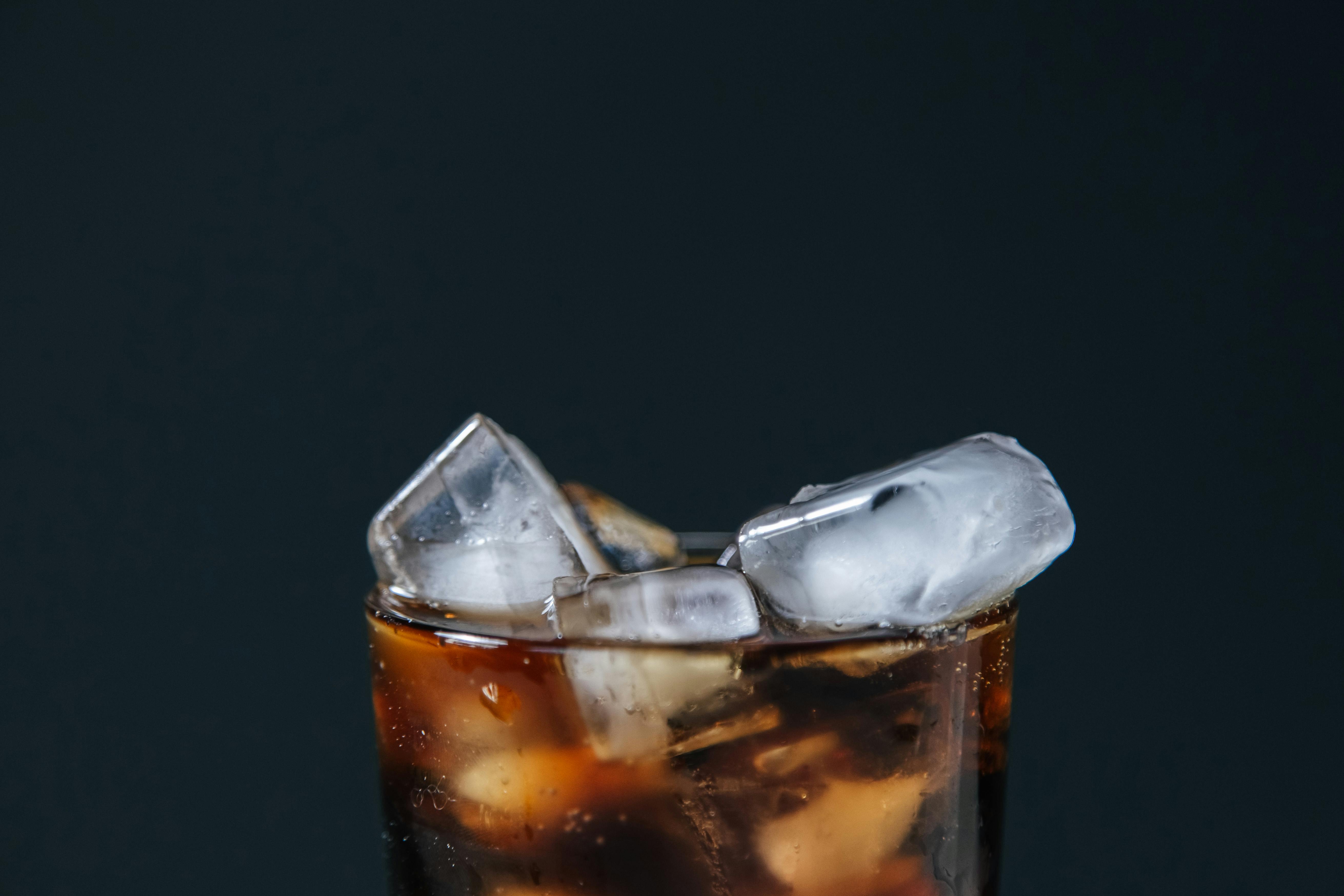 Soft drink cup with straw in cinema lighting